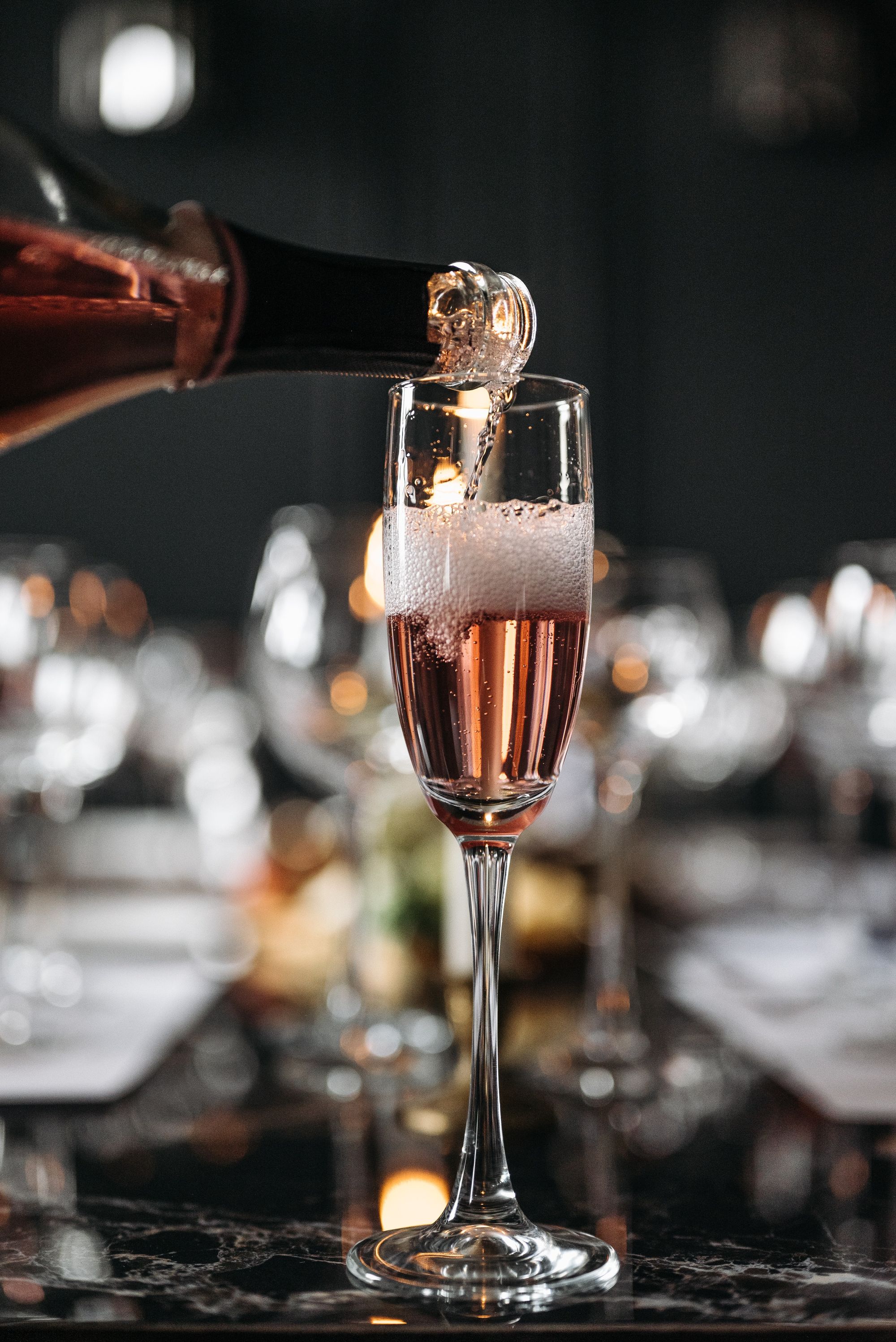 A person swirling a glass of red wine